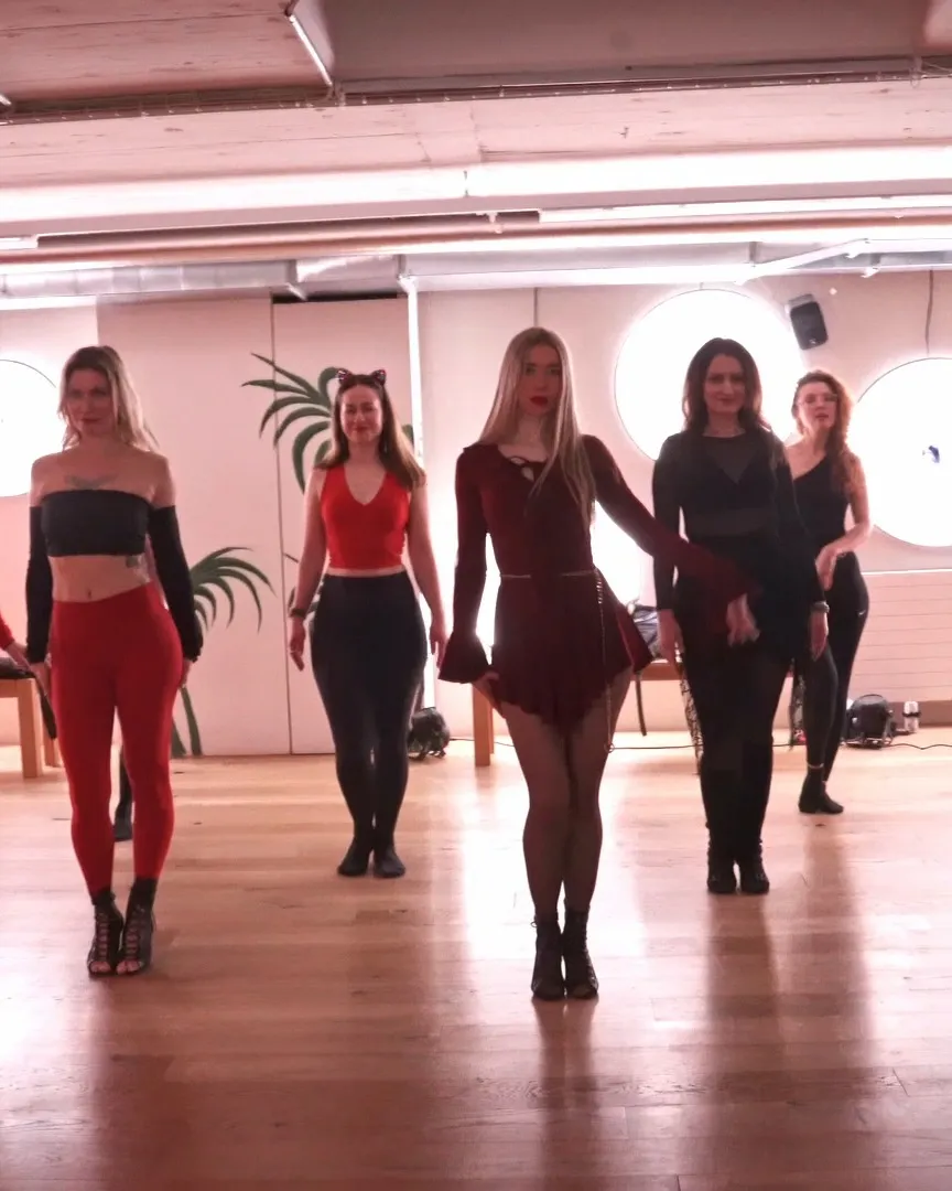 Five dancers in a High Heels class walking towards the camera side by side